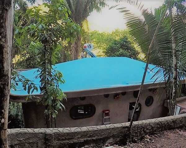 Hobbit-style cottage with blue roof on Lot 122