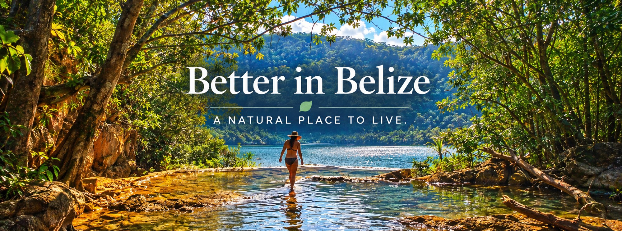 Better in Belize – A natural place to live. Woman wading into a clear jungle river pool