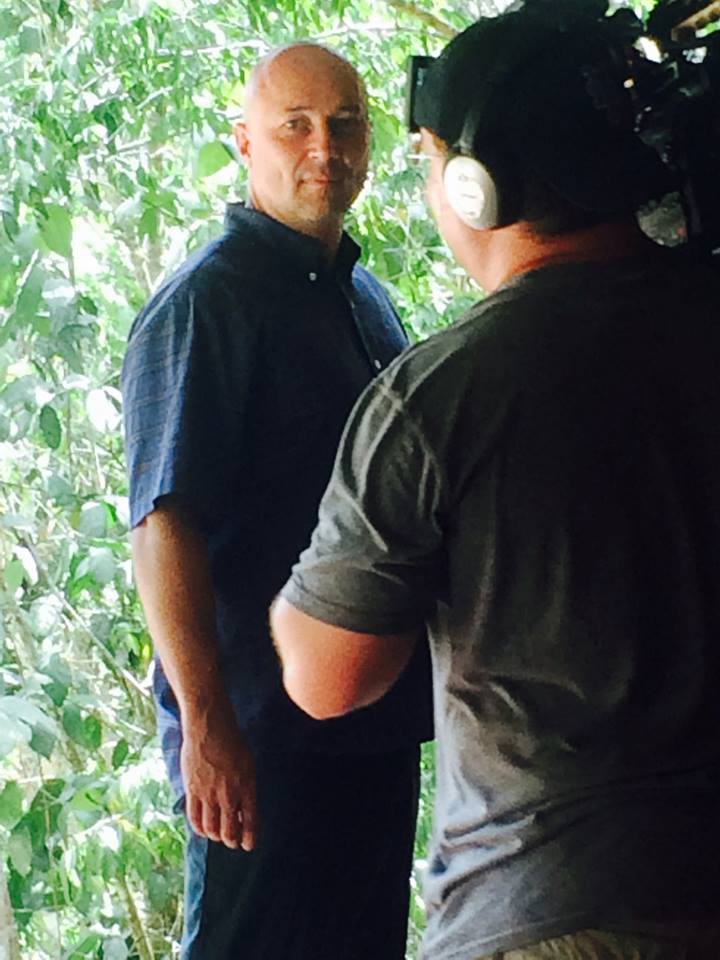 Steve on camera in front of the jungle during filming of House Hunters Off the Grid