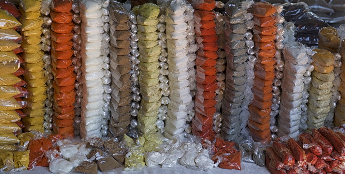 Bags of local spices and seasonings at a Cayo market