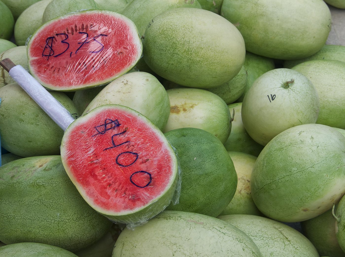 Fresh watermelons for sale at a Cayo farmers market