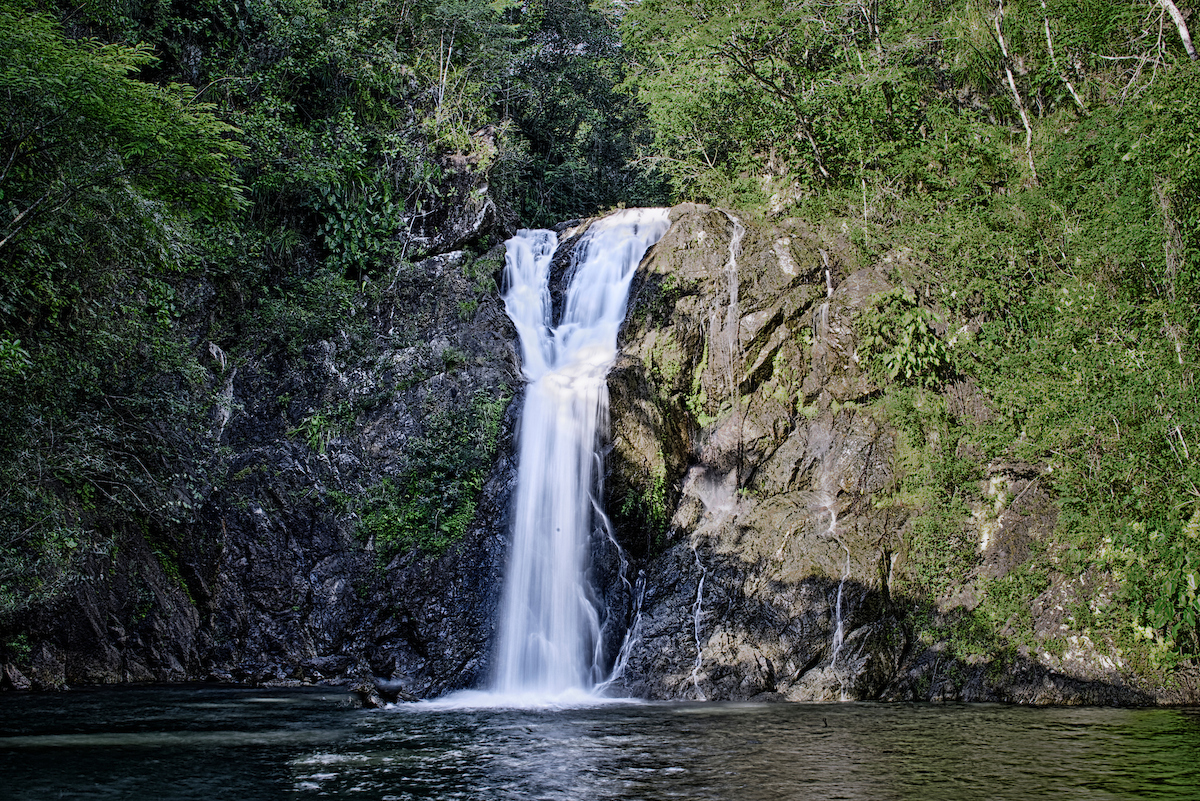 Waterfall cascading into a jungle swimming pool near Better in Belize